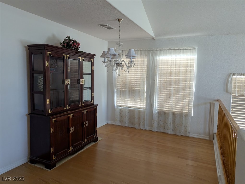 4777 Crakow Court Las Vegas, NV 89147 - Photo 12 of 49 Dining space with light wood finished floors and a chandelier