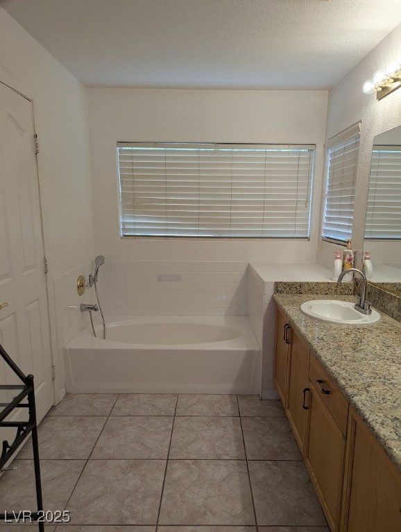 4777 Crakow Court Las Vegas, NV 89147 - Photo 17 of 49 Bathroom with vanity, a bath, and light tile patterned floors