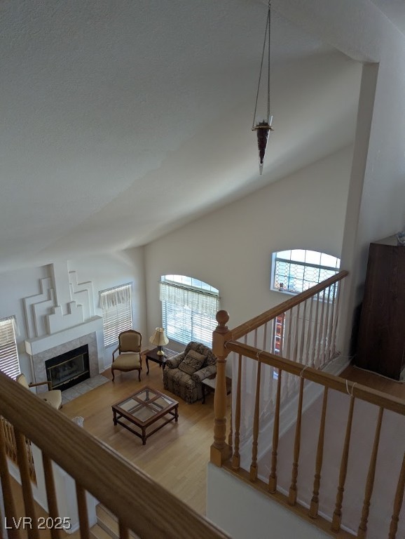 4777 Crakow Court Las Vegas, NV 89147 - Photo 22 of 49 Living room with a high end fireplace, light wood-style flooring, and vaulted ceiling