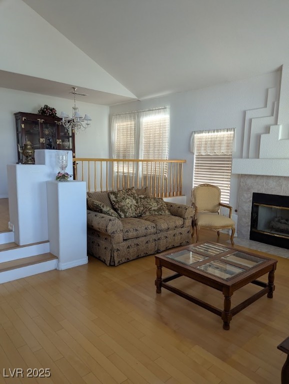 4777 Crakow Court Las Vegas, NV 89147 - Photo 28 of 49 Living room featuring wood finished floors, vaulted ceiling, and a fireplace