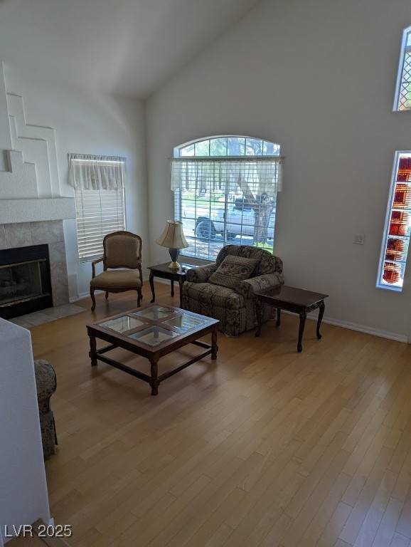 4777 Crakow Court Las Vegas, NV 89147 - Photo 29 of 49 Living area with light wood-style flooring, plenty of natural light, high vaulted ceiling, and a fireplace