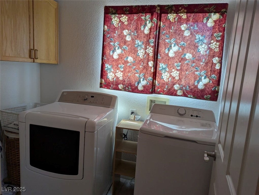 4777 Crakow Court Las Vegas, NV 89147 - Photo 41 of 49 Laundry area featuring a textured wall, independent washer and dryer, and cabinet space