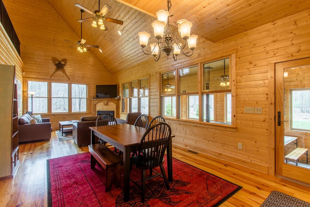 22447 German River Road Criders, VA 22820 - Photo 4 of 65 a dining room with wooden floor a chandelier a wooden table and chairs