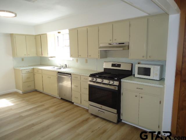 16994-c R 223 C R 223 Arp, TX 75750 - Photo 23 of 38 a kitchen with stainless steel appliances a stove a sink and white cabinets