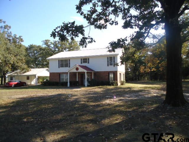 16994-c R 223 C R 223 Arp, TX 75750 - Photo 26 of 38 a front view of a house with a yard and trees