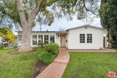 a kitchen with stainless steel appliances kitchen island a stove a table and chairs