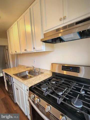 a stove top oven sitting inside of a kitchen