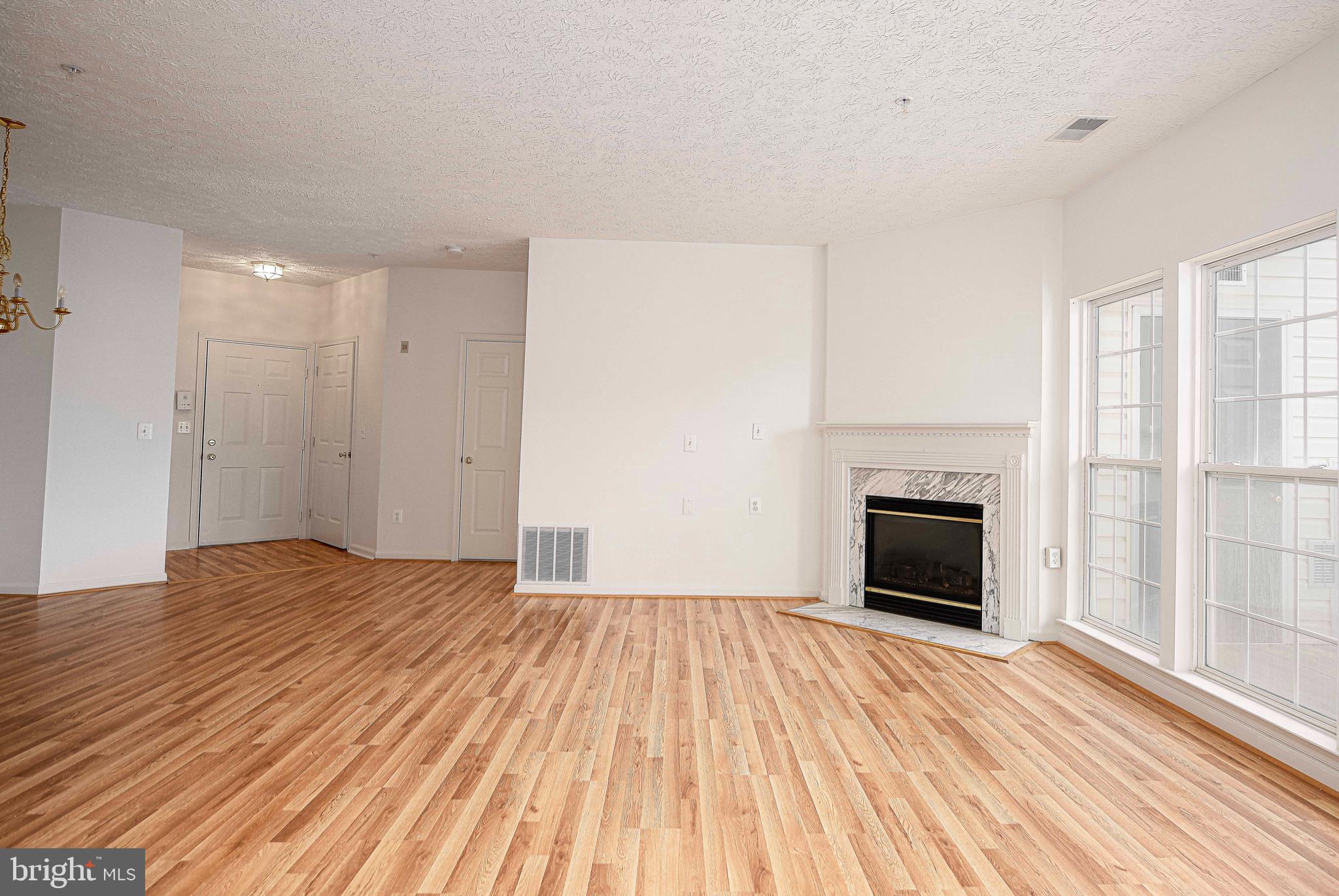 9606 Haven Farm Road, Unit E Perry Hall, MD 21128 - Photo 11 of 33 a view of empty room with wooden floor and fireplace