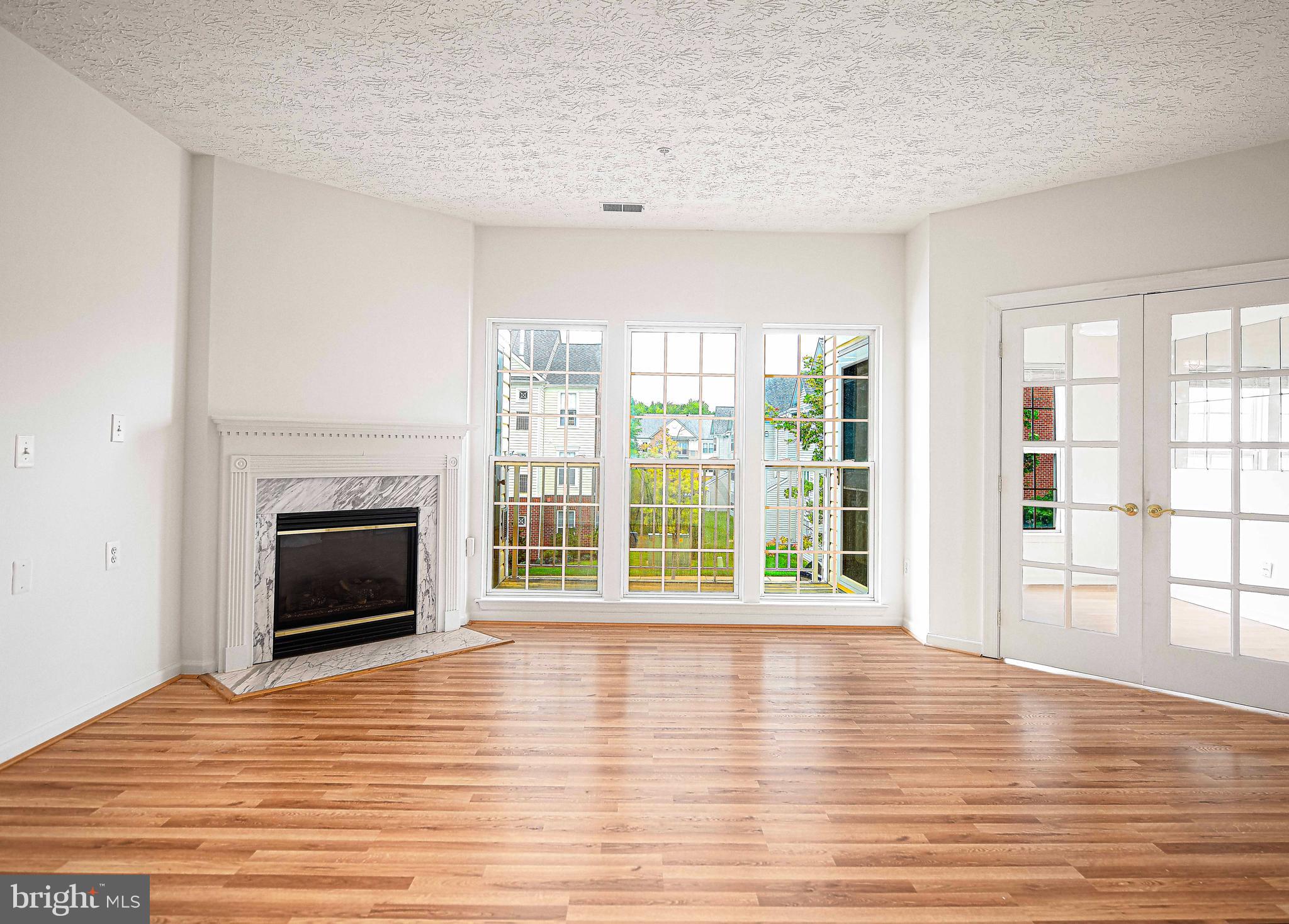 9606 Haven Farm Road, Unit E Perry Hall, MD 21128 - Photo 14 of 33 a view of an empty room with wooden floor and a window