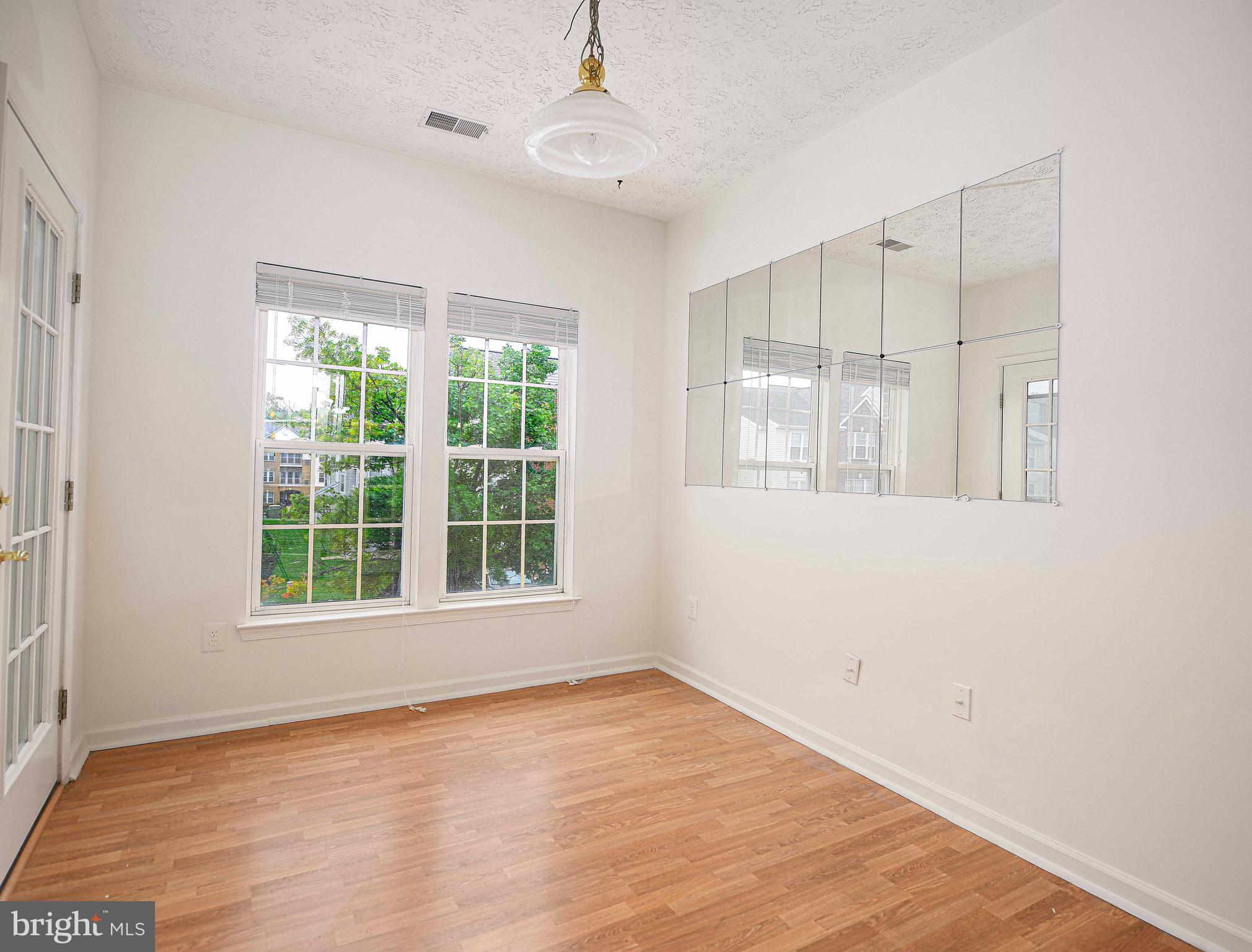 9606 Haven Farm Road, Unit E Perry Hall, MD 21128 - Photo 18 of 33 wooden floor in an empty room with a window