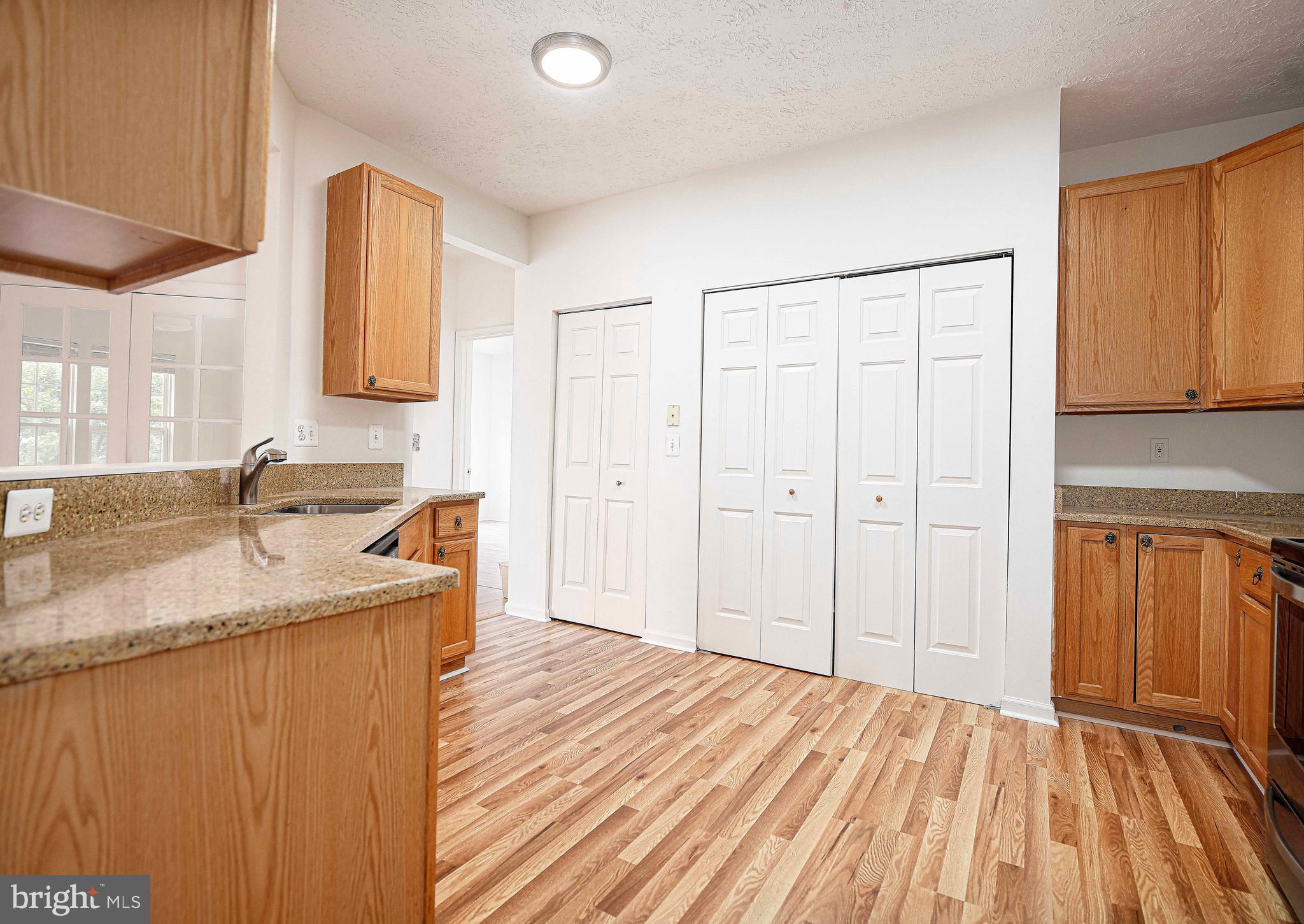 9606 Haven Farm Road, Unit E Perry Hall, MD 21128 - Photo 23 of 33 a view of a kitchen with a sink dishwasher refrigerator and cabinets