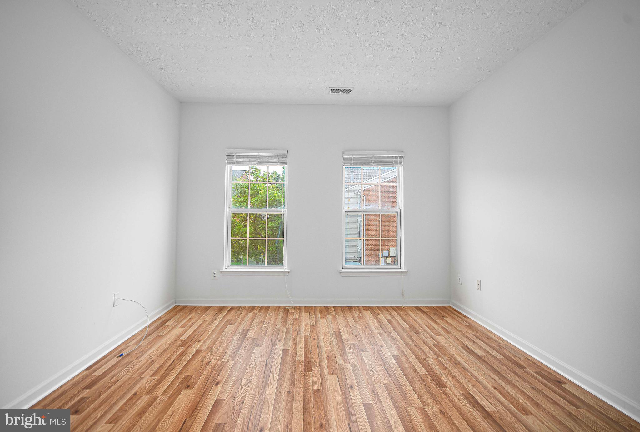 9606 Haven Farm Road, Unit E Perry Hall, MD 21128 - Photo 27 of 33 an empty room with wooden floor and windows