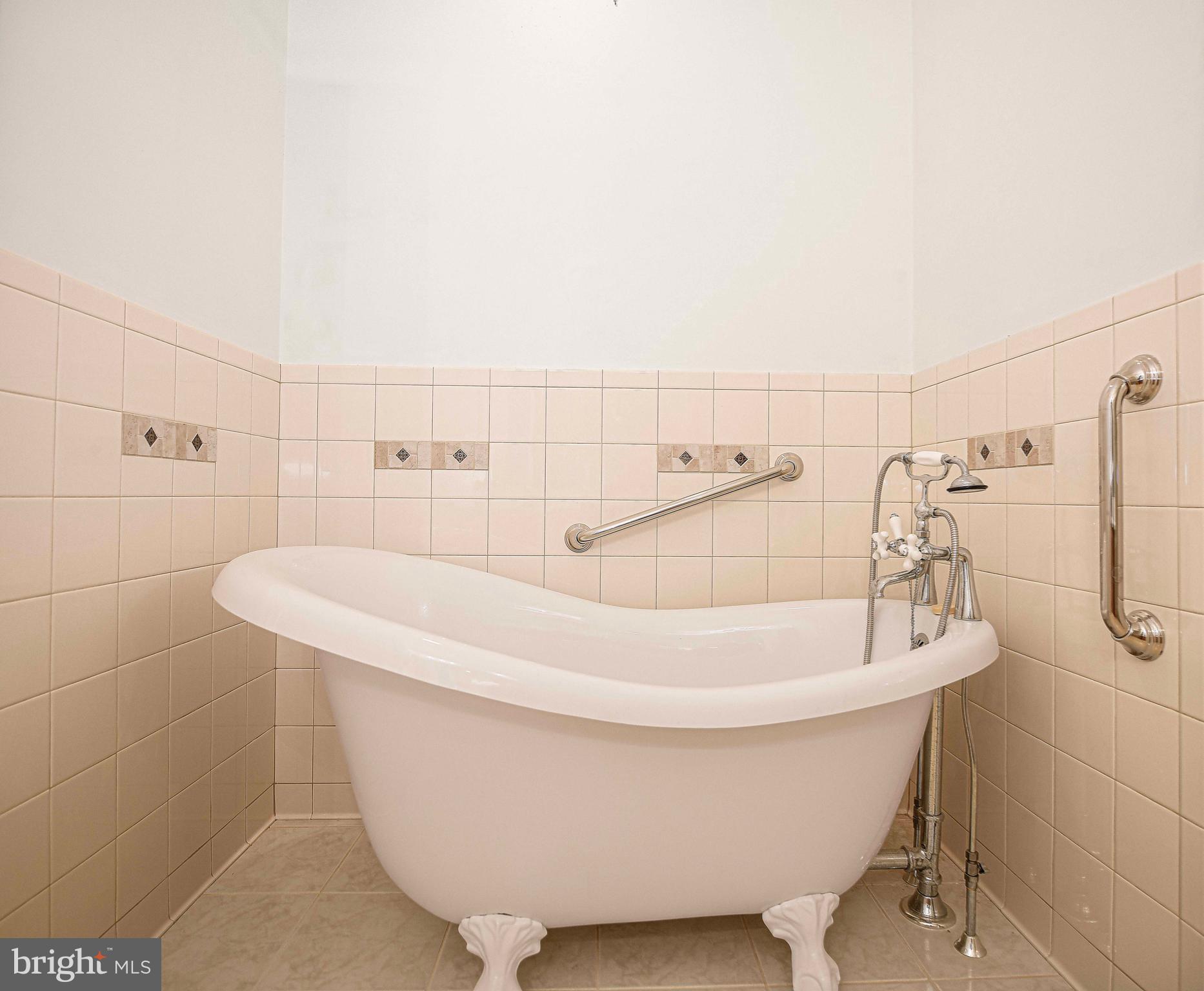 9606 Haven Farm Road, Unit E Perry Hall, MD 21128 - Photo 29 of 33 a white bath tub sitting in a bathroom