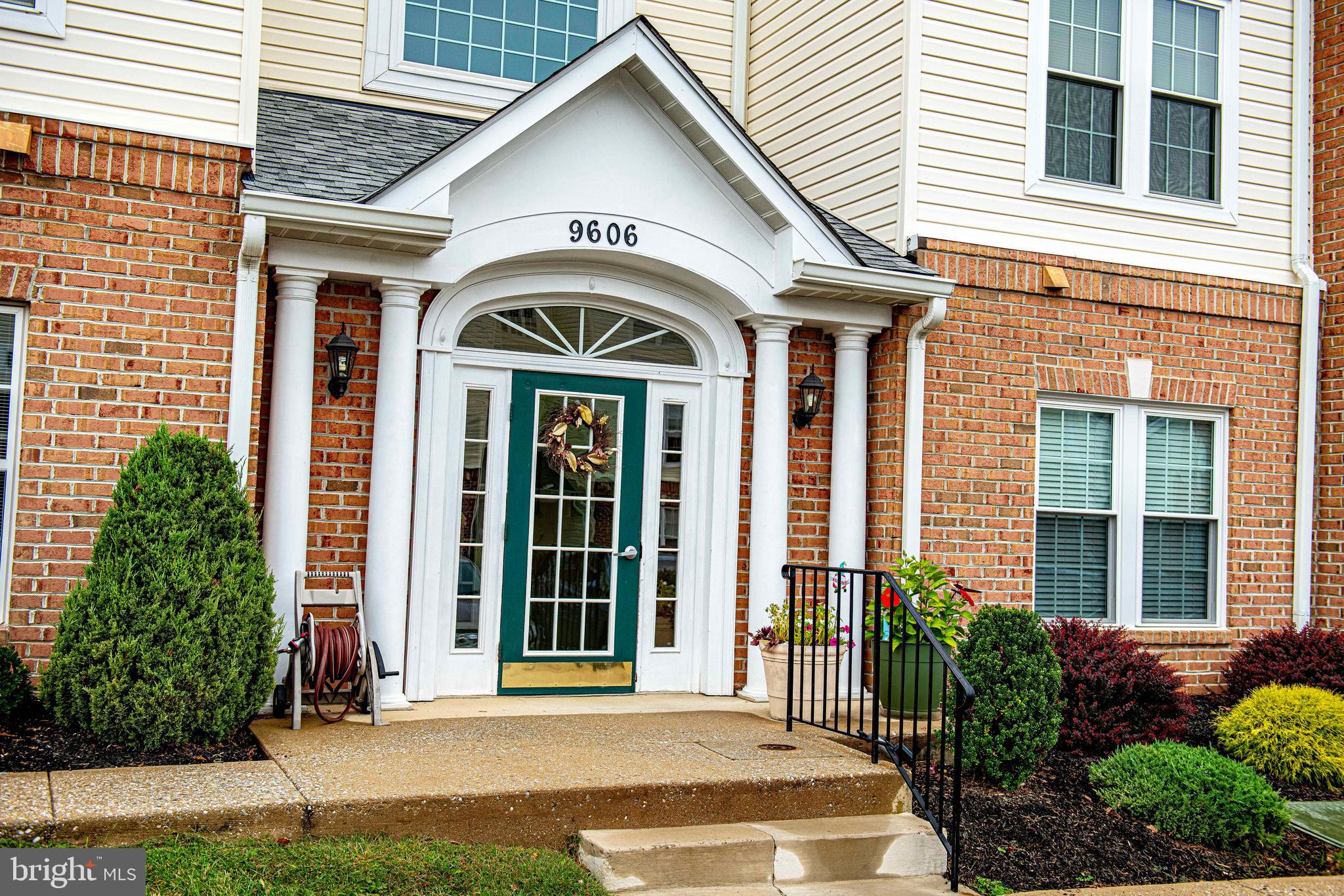 9606 Haven Farm Road, Unit E Perry Hall, MD 21128 - Photo 33 of 33 a view of a brick house with a large windows and plants