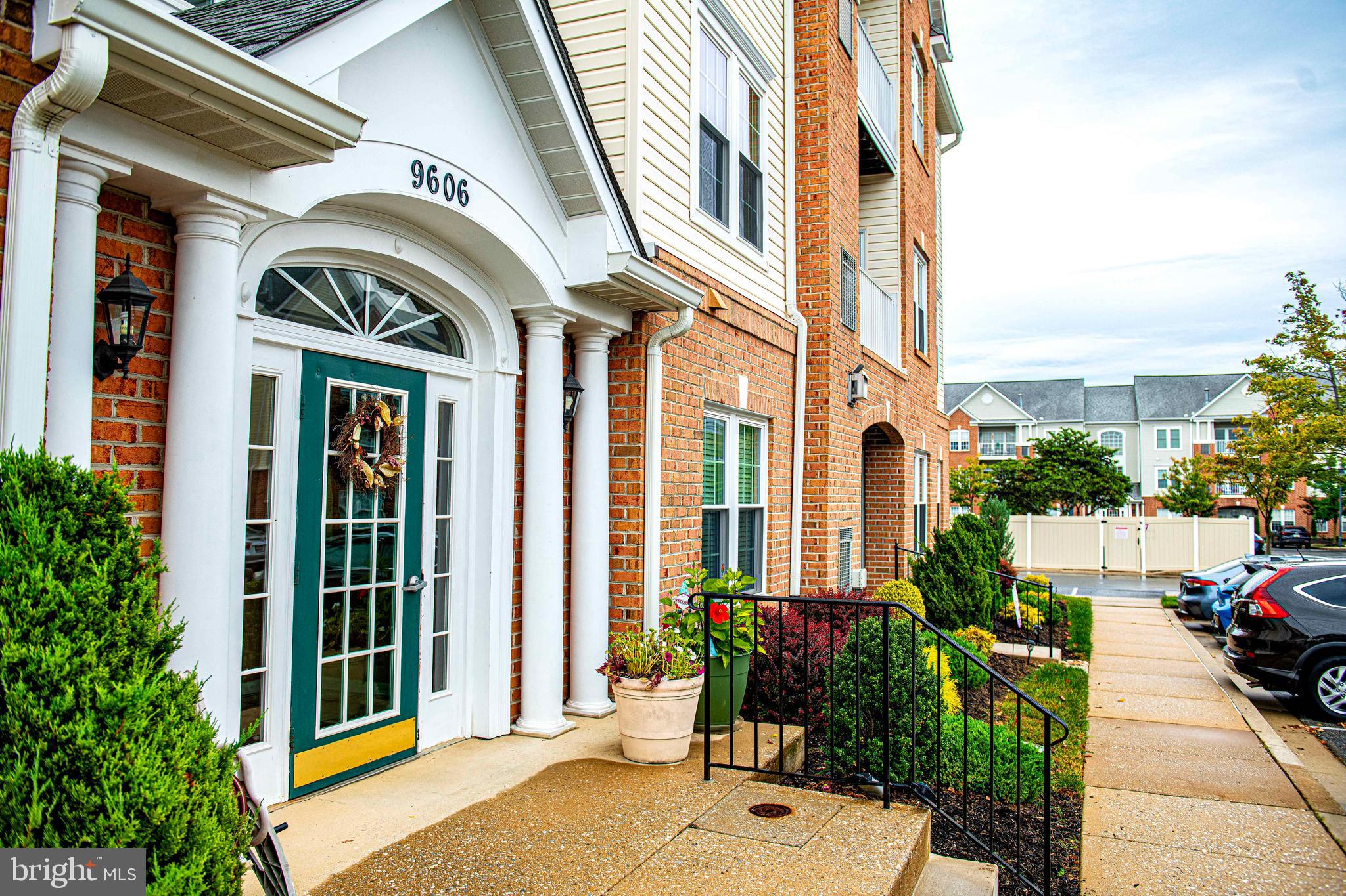 9606 Haven Farm Road, Unit E Perry Hall, MD 21128 - Photo 4 of 33 a view of a building with a potted plant ana a small yard
