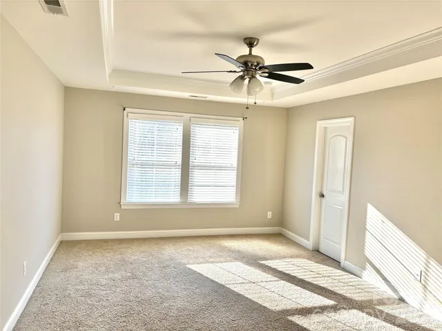 a view of a livingroom with a ceiling fan and window