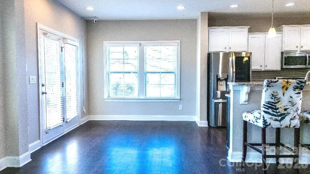 a view of livingroom with furniture wooden floor and windows