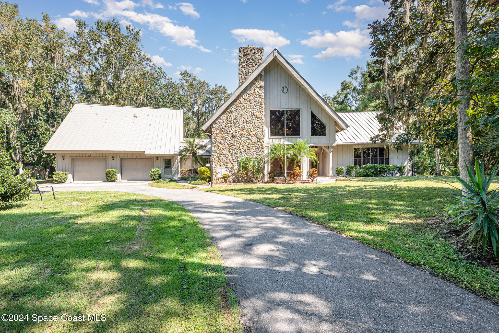 3450 Grant Line Road Mims, FL 32754 - Photo 1 of 42 a front view of house with yard and green space