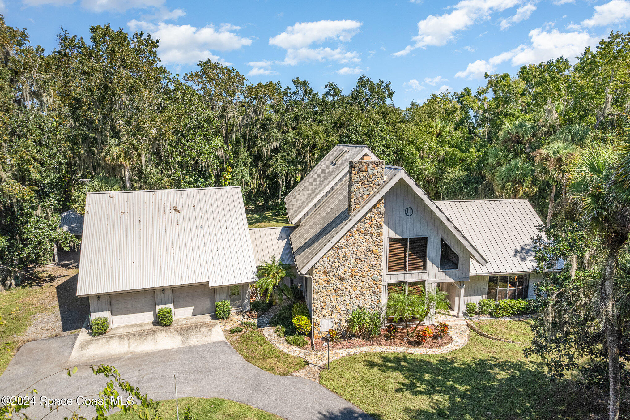 3450 Grant Line Road Mims, FL 32754 - Photo 3 of 42 a front view of a house with garden