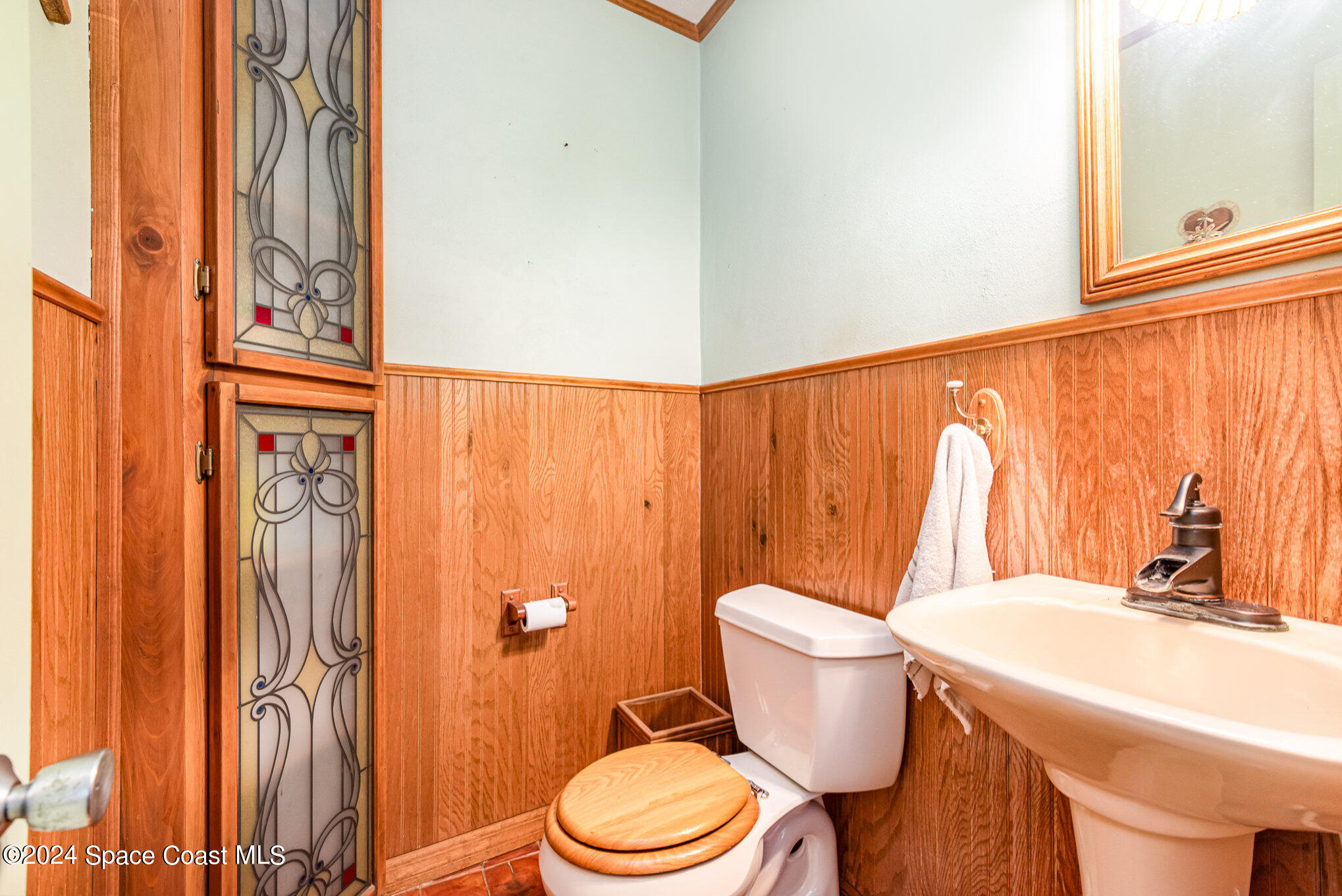 3450 Grant Line Road Mims, FL 32754 - Photo 31 of 42 a bathroom with a toilet a sink and a window
