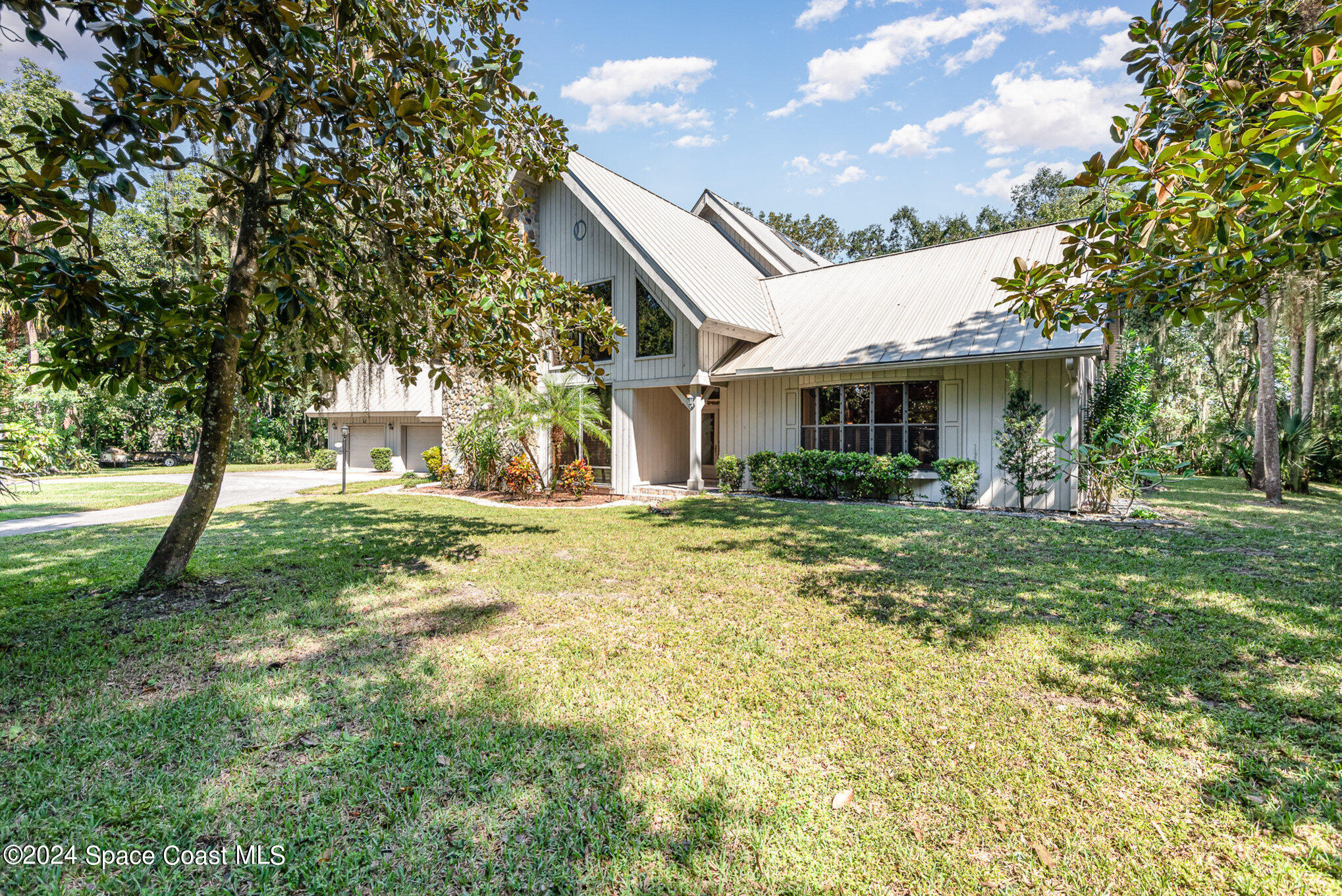 3450 Grant Line Road Mims, FL 32754 - Photo 4 of 42 a front view of a house with garden