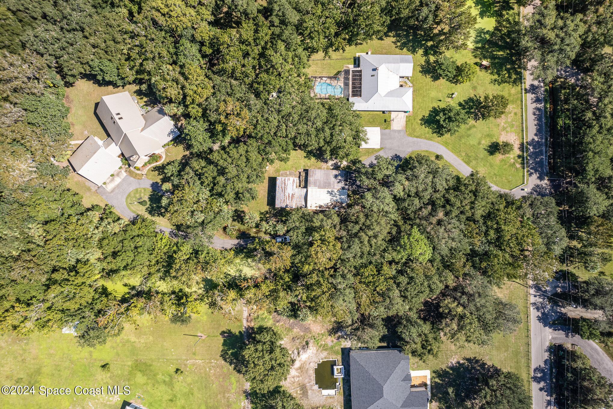 3450 Grant Line Road Mims, FL 32754 - Photo 42 of 42 an aerial view of a house with swimming pool and garden space