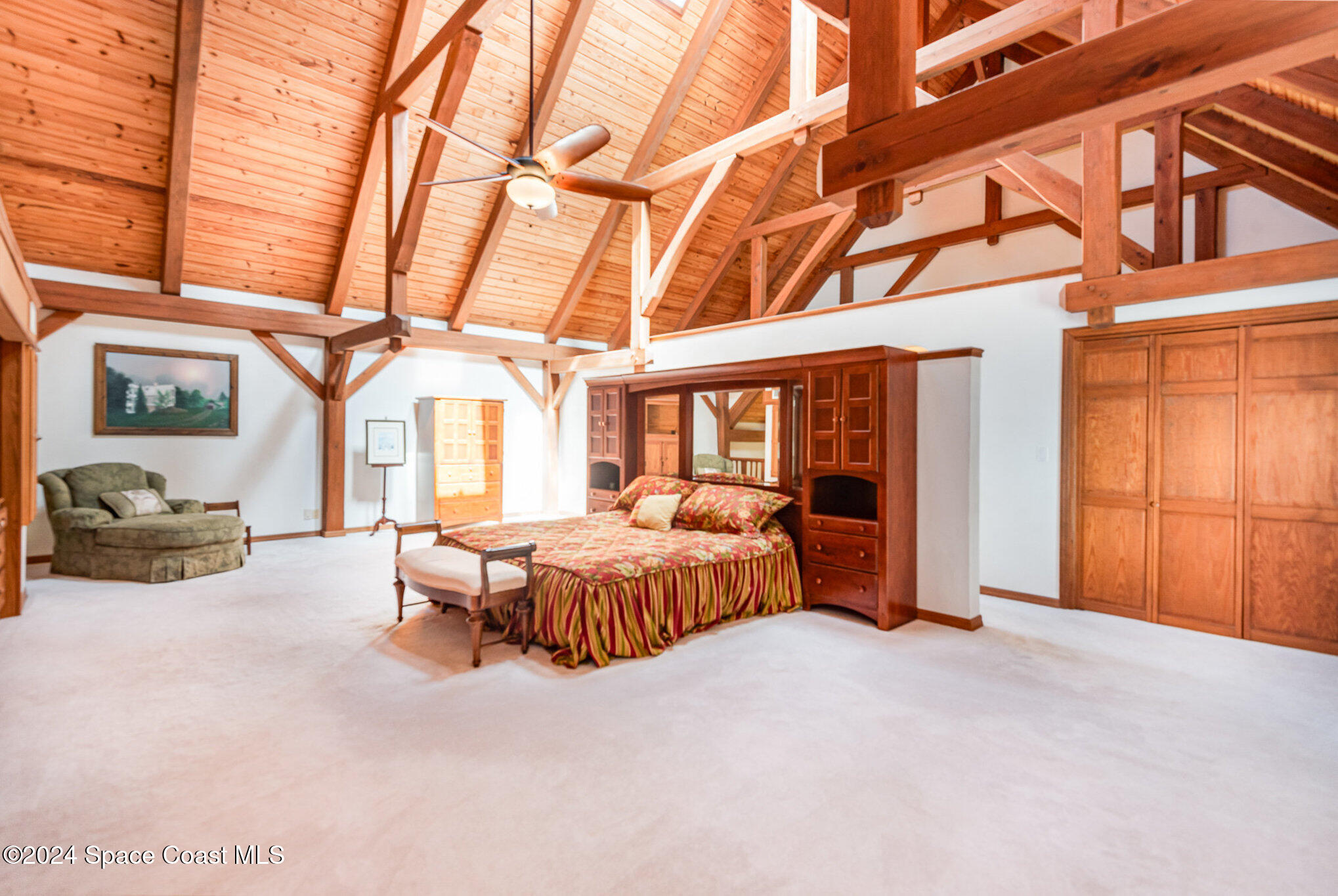 3450 Grant Line Road Mims, FL 32754 - Photo 10 of 42 a spacious bedroom with a bed and a large window