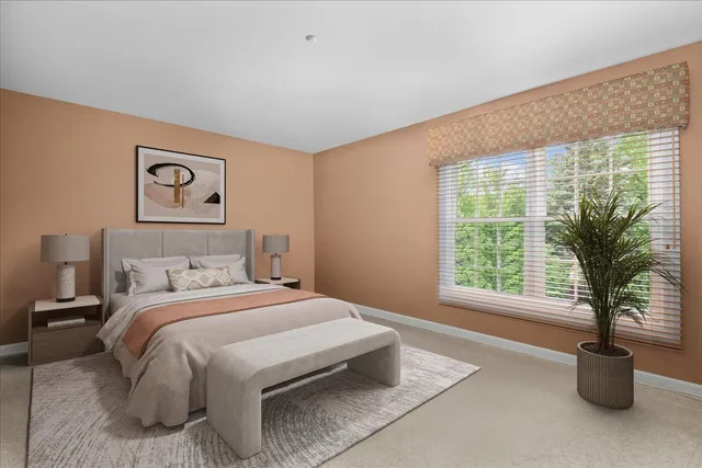 a bedroom with a large bed and a large window