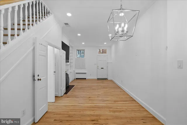 a view of a hallway with wooden floor