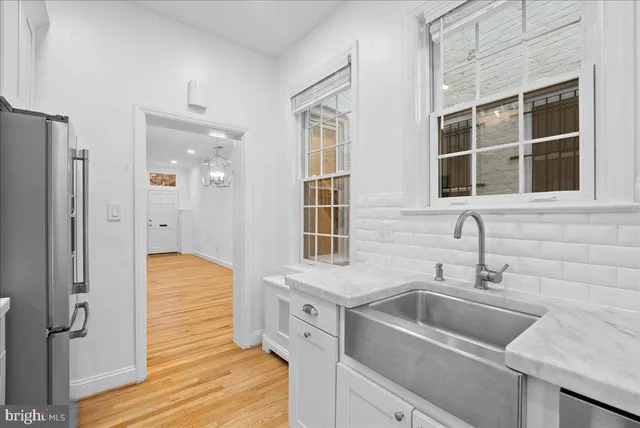 a kitchen with a sink and refrigerator