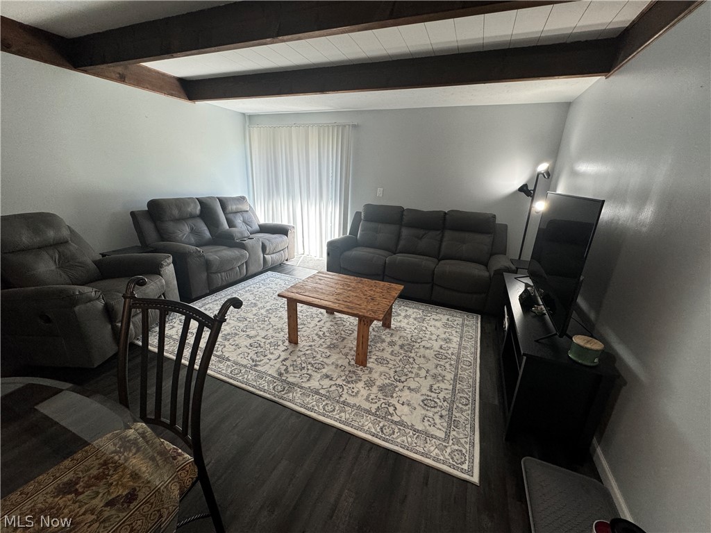 5219 D Cline Road Kent, OH 44240 - Photo 6 of 12 Living room with beam ceiling and vinyl plank flooring. Slider goes out to your updated concrete patio.