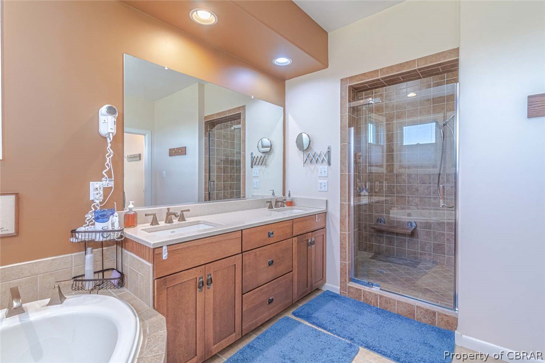 364 Captains Way Reedville, VA 22539 - Photo 37 of 50 Primary Bedroom's Bathroom with double sink vanity, soaking tub, tile shower