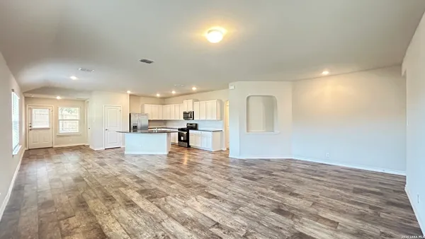 a view of kitchen with kitchen island dining table and chairs