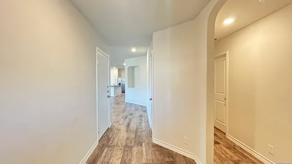 a view of a hallway with wooden floor
