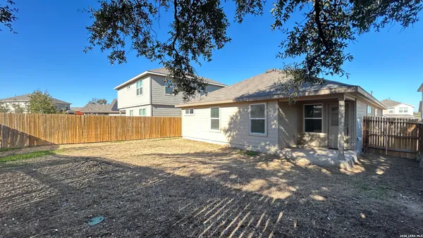a front view of a house with a garden and yard
