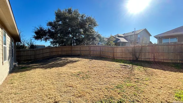 a view of wooden fence in front of house