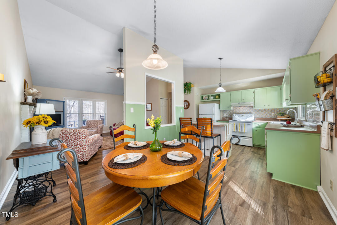 1008 Torredge Road Durham, NC 27712 - Photo 16 of 31 a view of a dining room with furniture wooden floor and chandelier