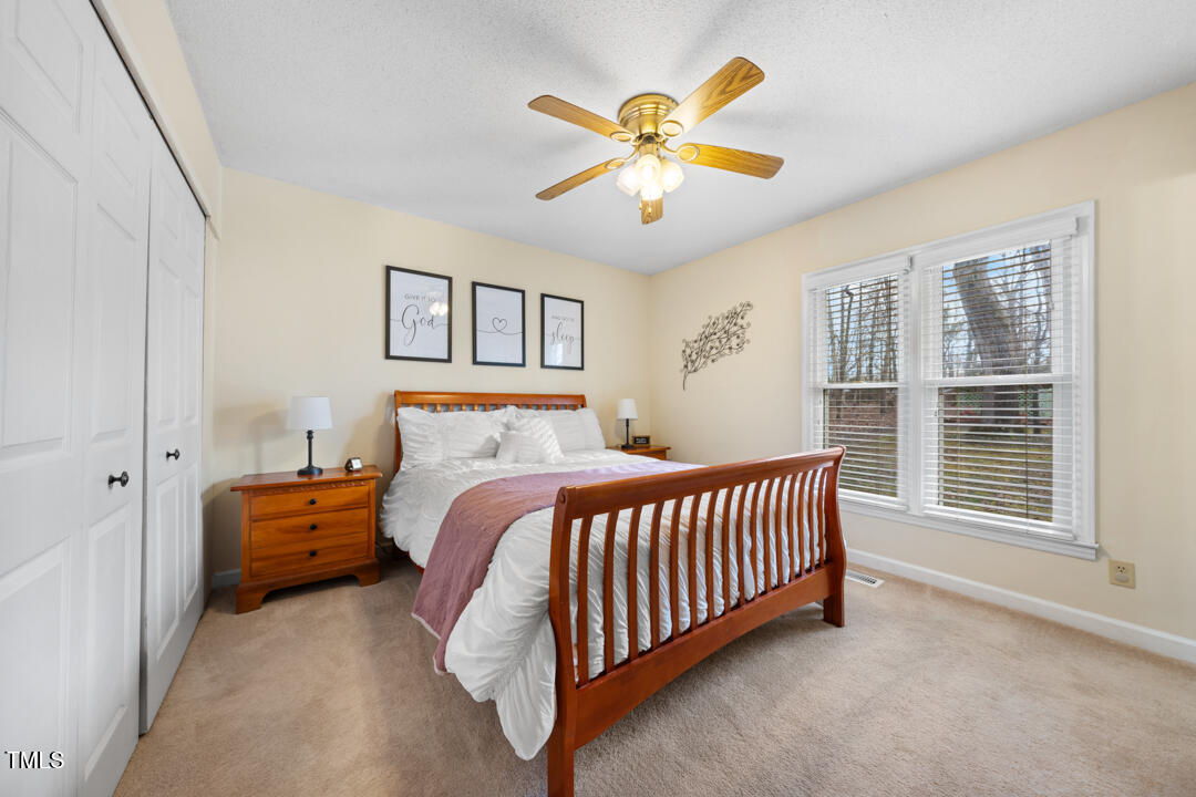 1008 Torredge Road Durham, NC 27712 - Photo 26 of 31 a bedroom with a bed and a chandelier
