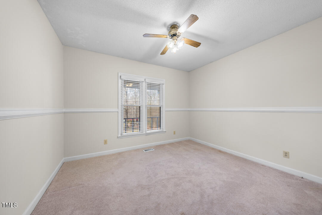 1008 Torredge Road Durham, NC 27712 - Photo 28 of 31 an empty room with a window and a fan