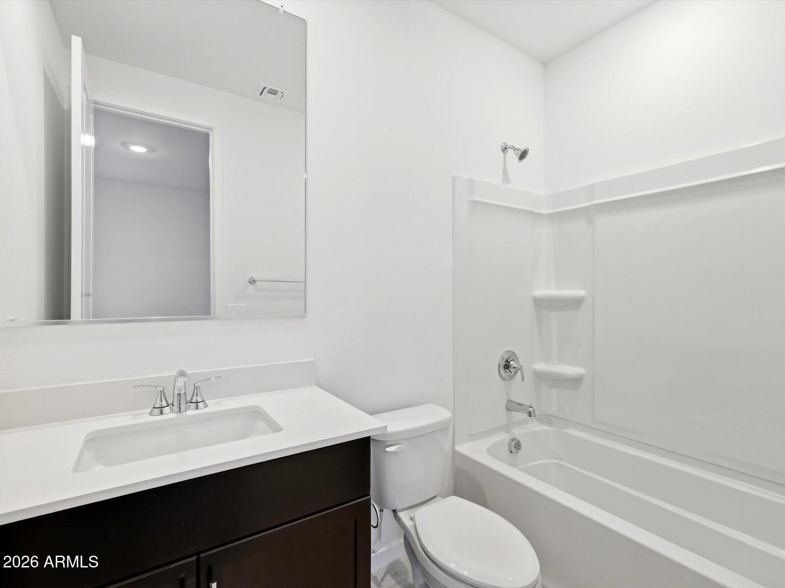 2392 Grenache Road San Tan Valley, AZ 85143 - Photo 10 of 67 a bathroom with a sink a toilet and bathtub