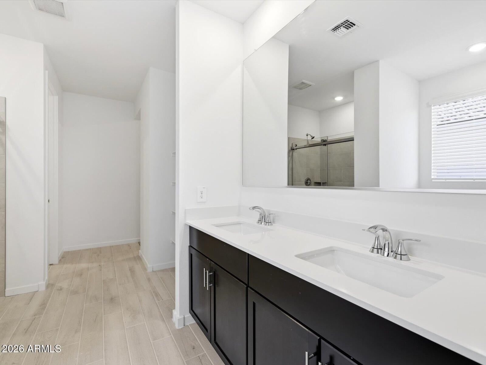 2392 Grenache Road San Tan Valley, AZ 85143 - Photo 14 of 67 a bathroom with a sink double vanity granite and a mirror