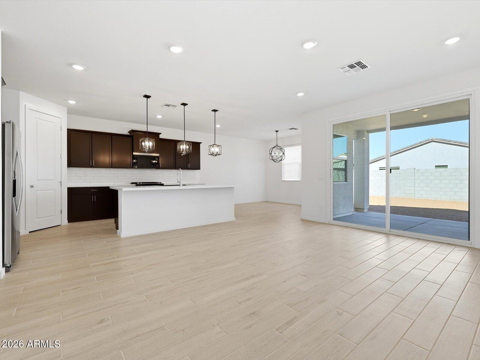 2392 Grenache Road San Tan Valley, AZ 85143 - Photo 17 of 67 a big room with kitchen view and a refrigerator