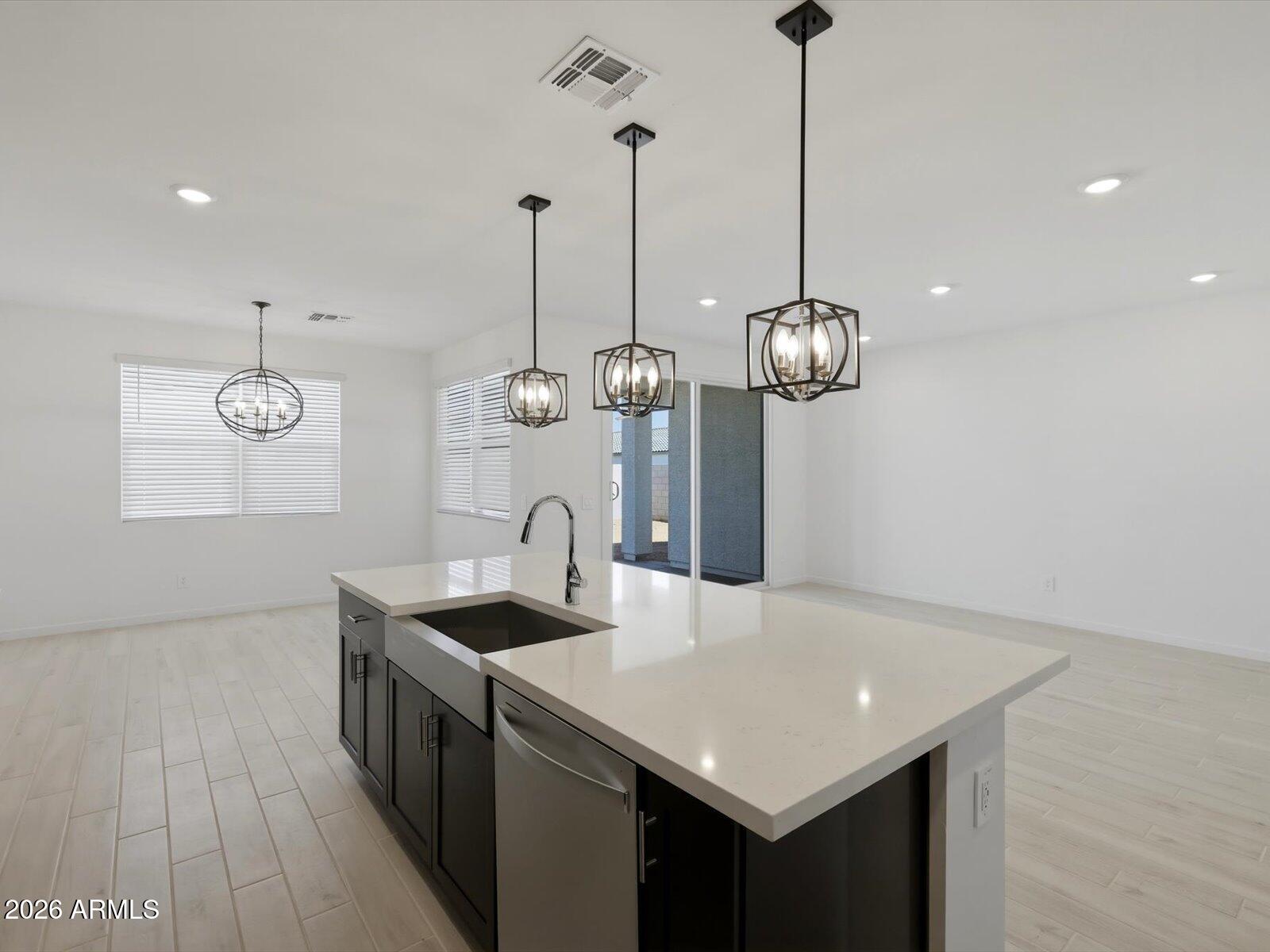 2392 Grenache Road San Tan Valley, AZ 85143 - Photo 23 of 67 a kitchen with granite countertop a sink a counter space and wooden floor