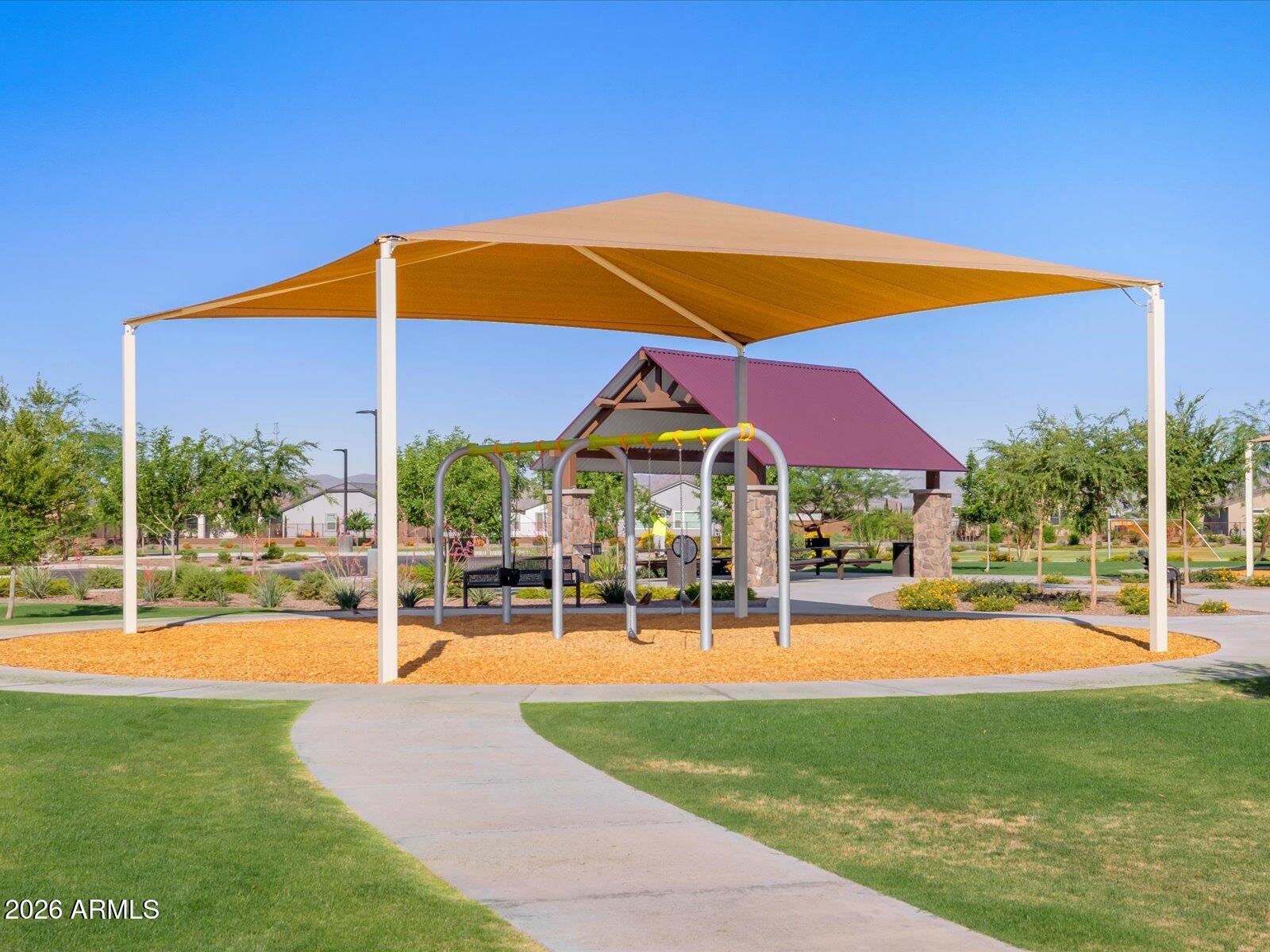2392 Grenache Road San Tan Valley, AZ 85143 - Photo 38 of 67 a view of pool with a table and chairs under an umbrella