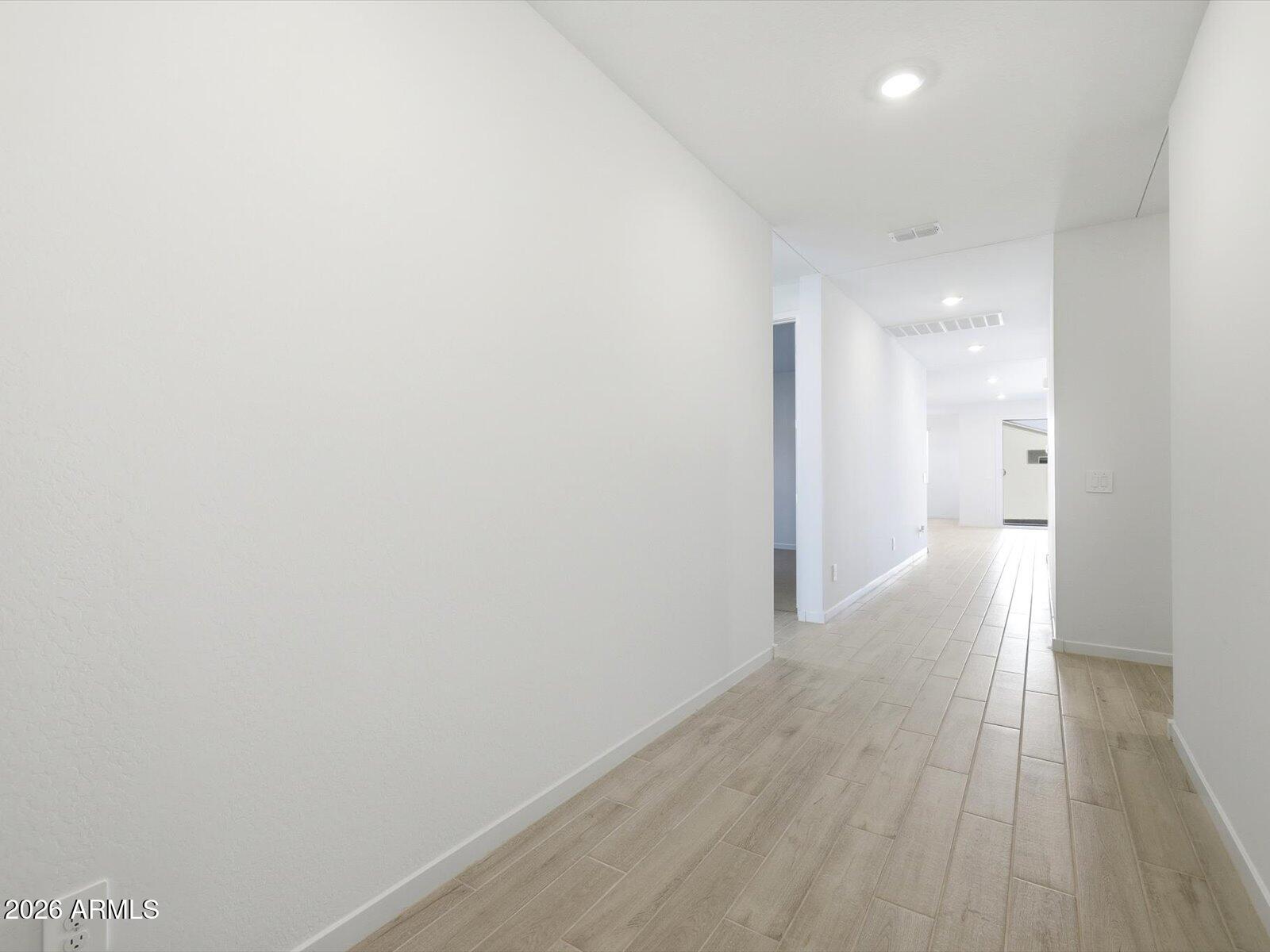 2392 Grenache Road San Tan Valley, AZ 85143 - Photo 4 of 67 a view of a hallway with wooden floor