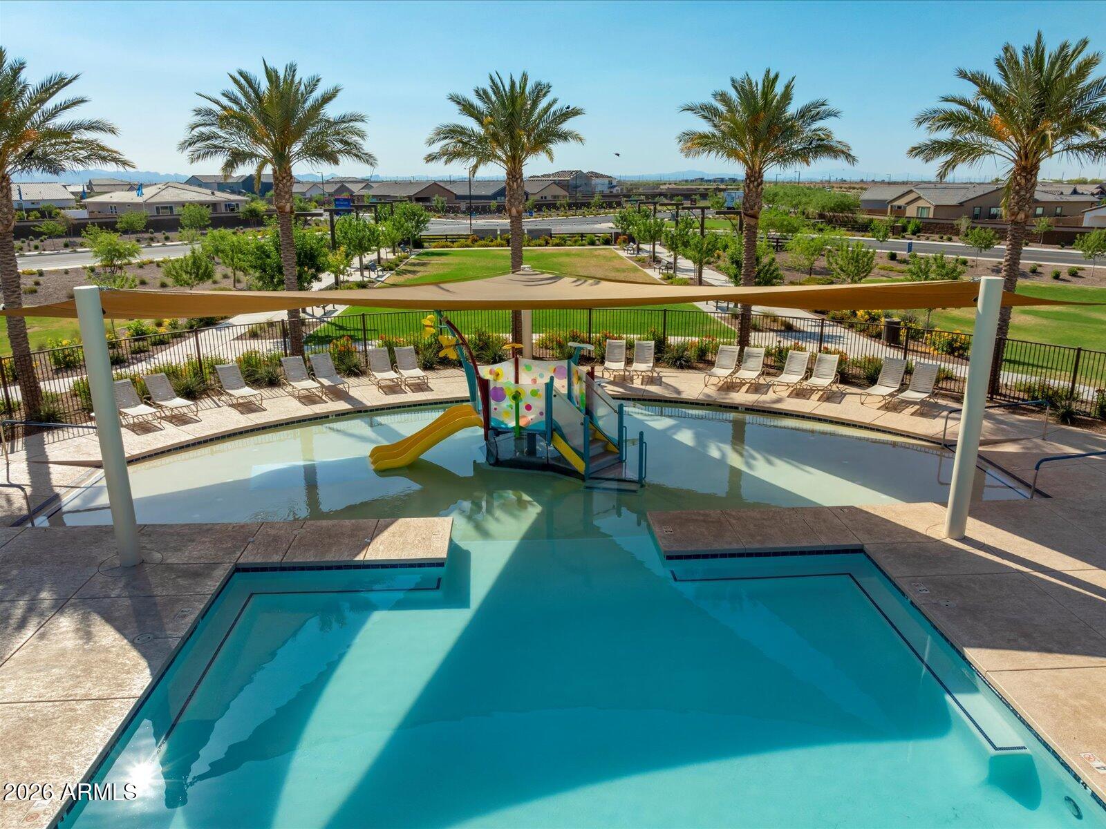 2392 Grenache Road San Tan Valley, AZ 85143 - Photo 61 of 67 a view of a swimming pool with a table and chairs in patio
