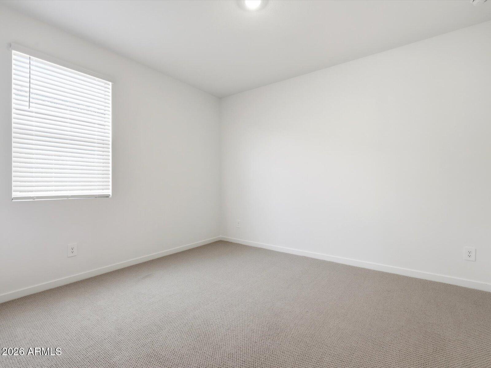 2392 Grenache Road San Tan Valley, AZ 85143 - Photo 7 of 67 an empty room with a window