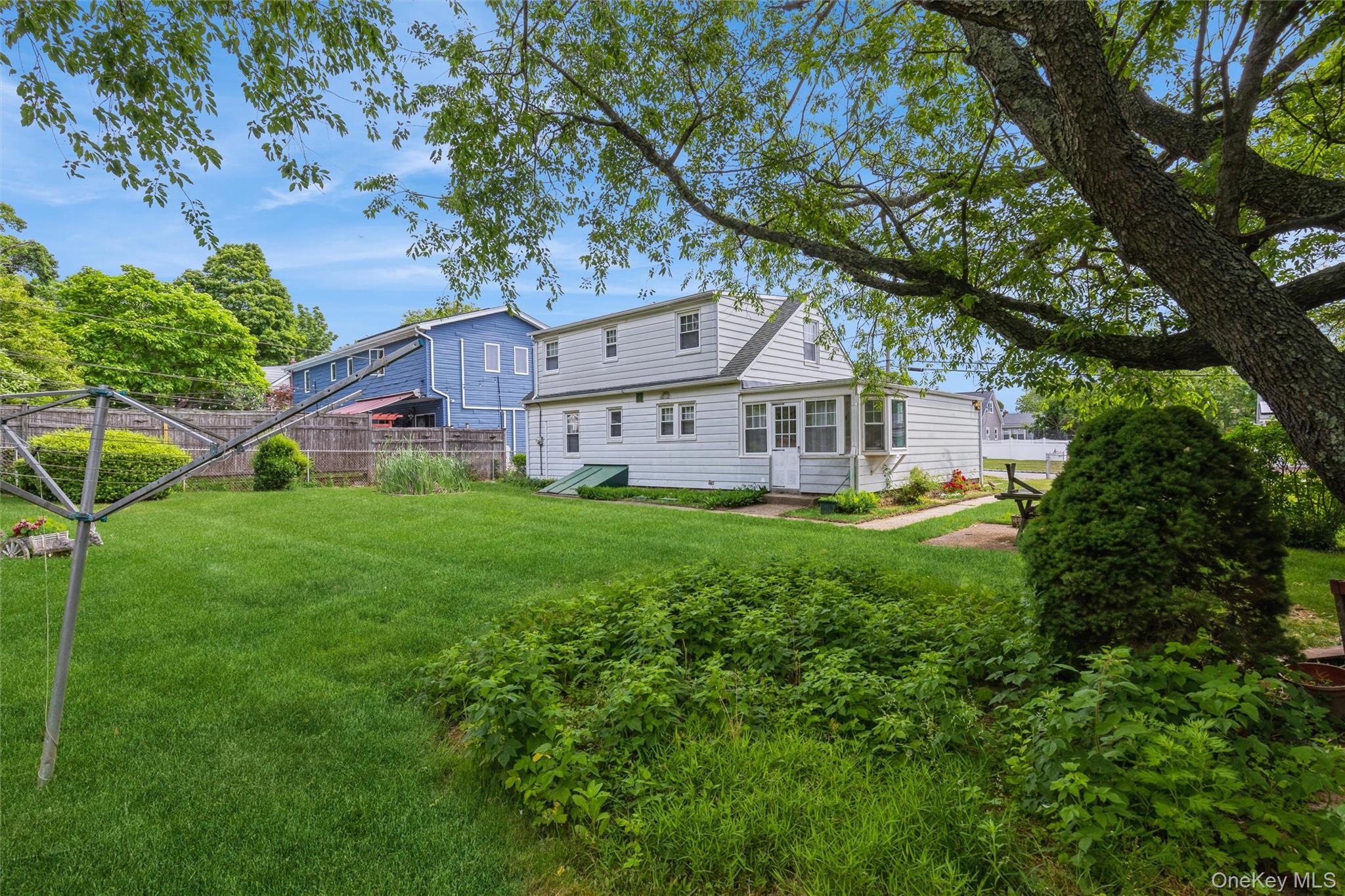 10 Laurel Road Ronkonkoma, NY 11779 - Photo 18 of 21 a front view of house with yard and green space