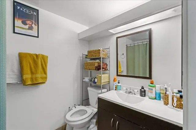 a bathroom with a toilet sink and mirror