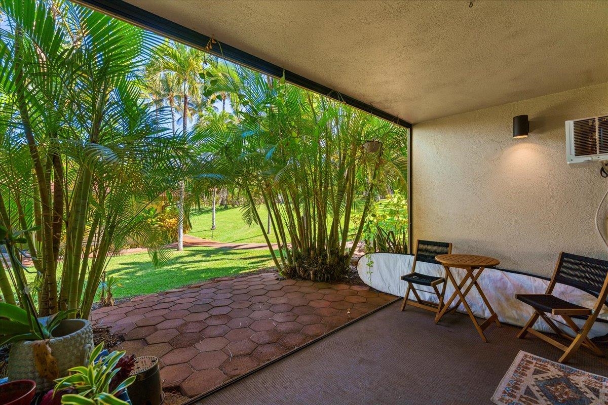 3788 Lower Honoapiilani Road, Unit A114 Lahaina, HI 96761 - Photo 13 of 18 a backyard of a house with table and chairs